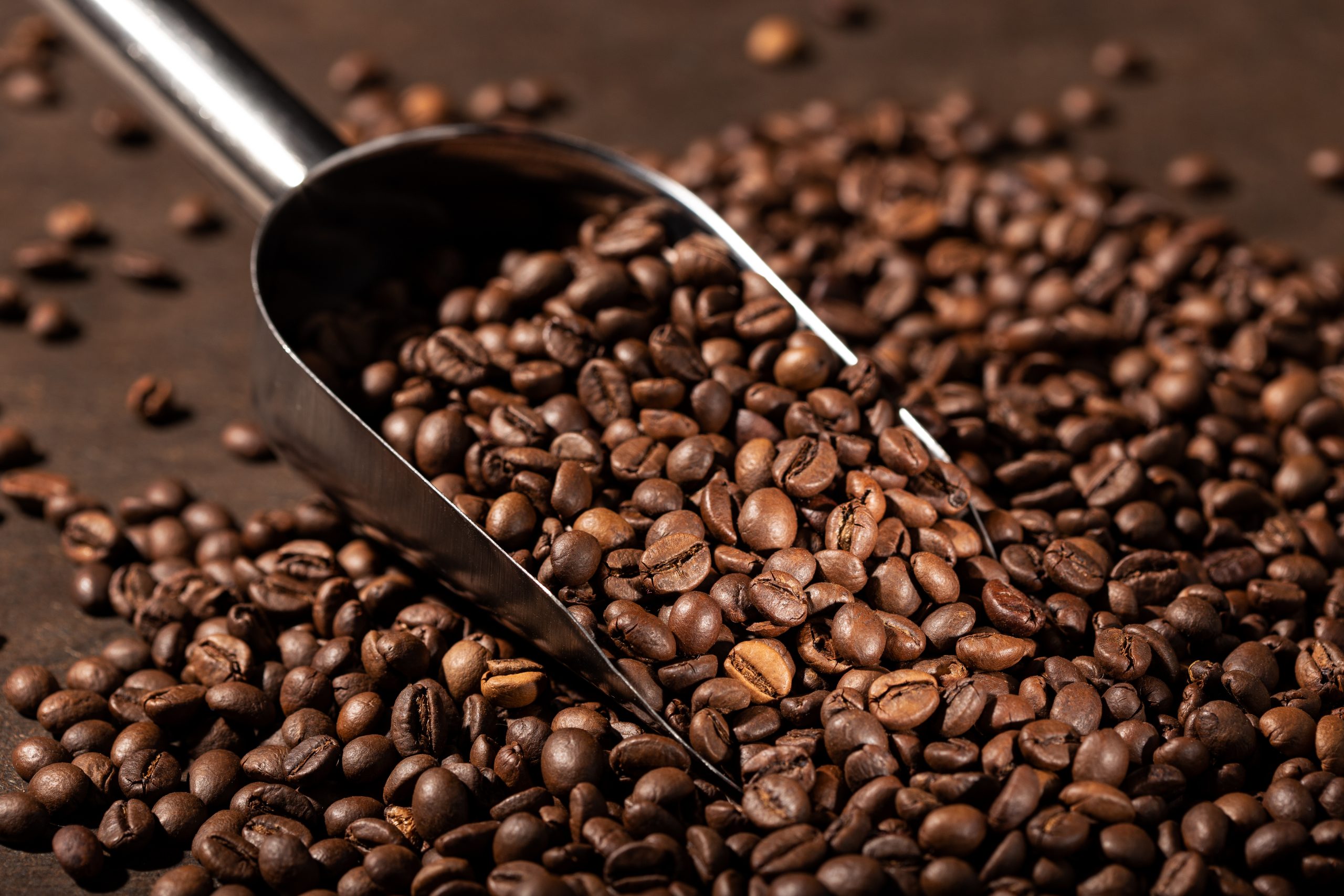 Coffee background. Roasted Coffee beans and scoop