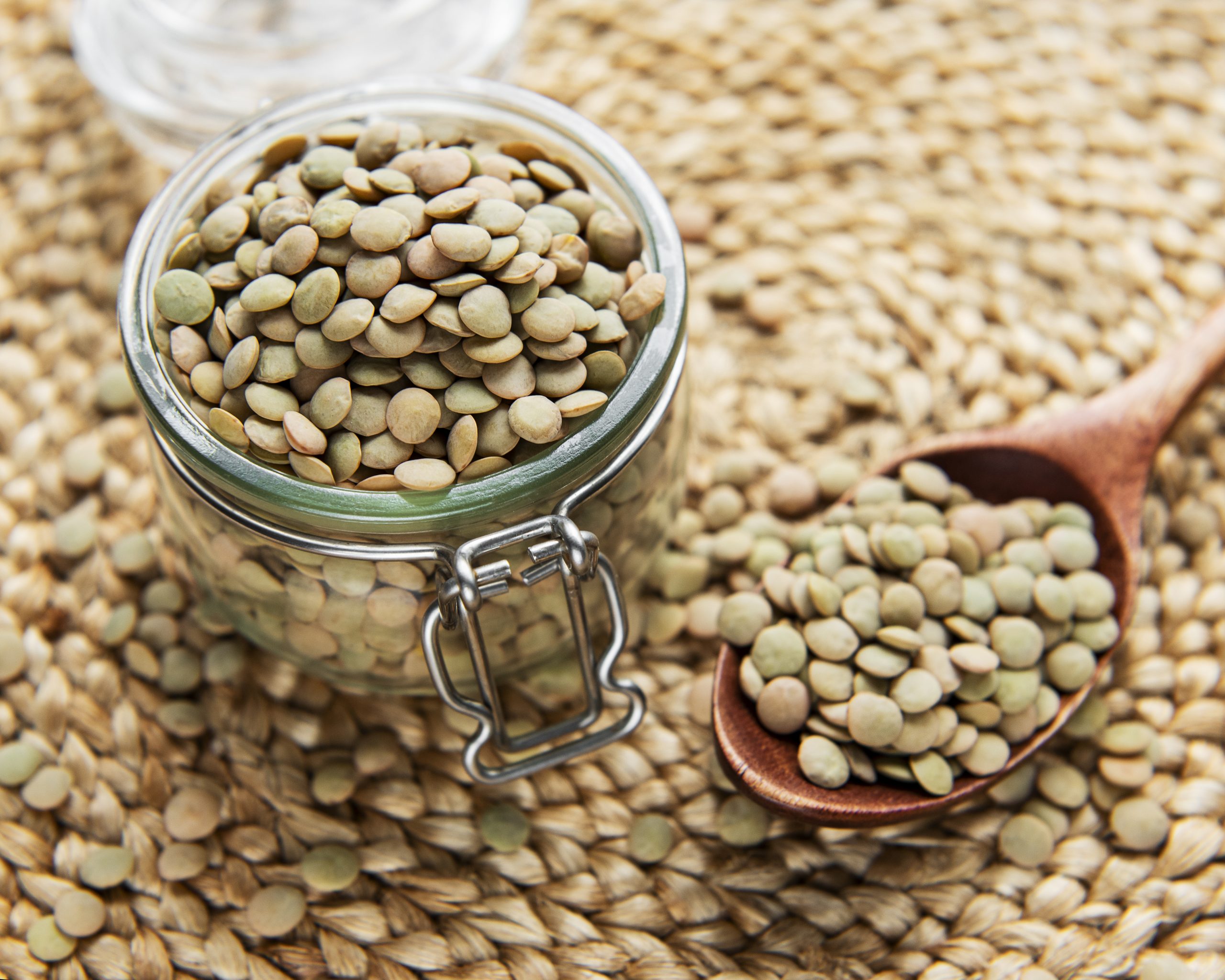 Pile of raw lentil in a glass jar on a table